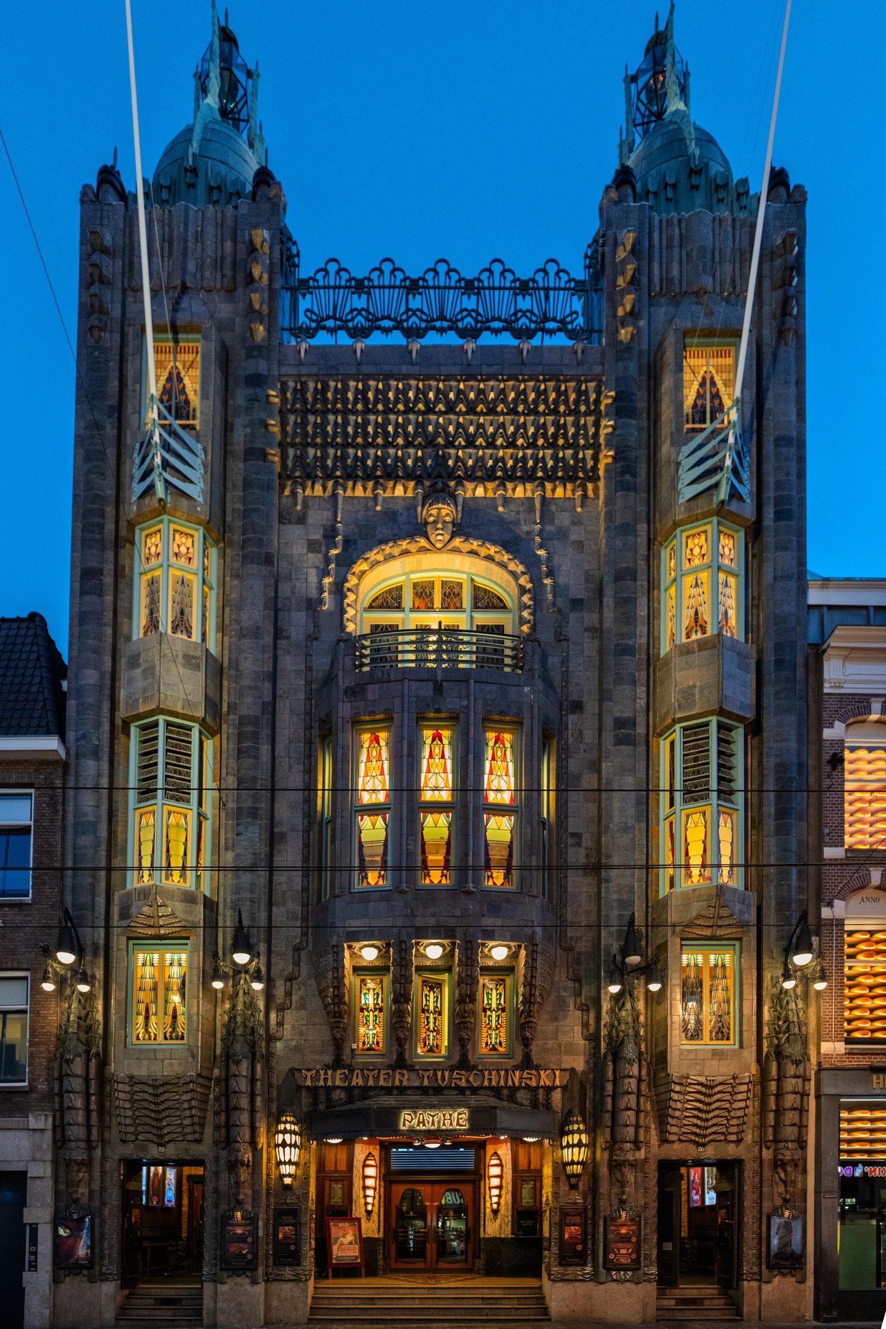 Art Deco façade of Theater Tuschinski lit at blue hour, Amsterdam