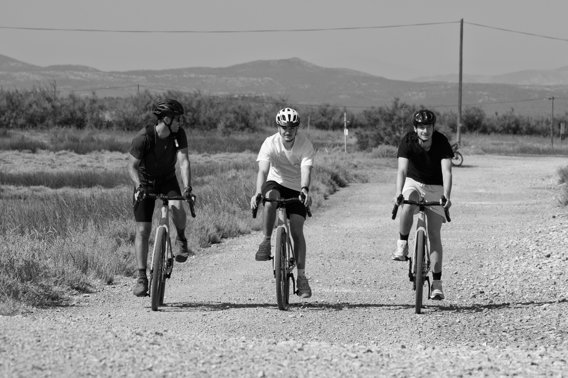 Cyclists riding toward the old iron bridge, Gruissan