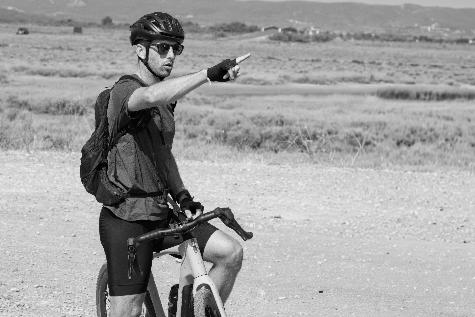 Cyclist on a gravel path through the Gruissan lagoons, black and white
